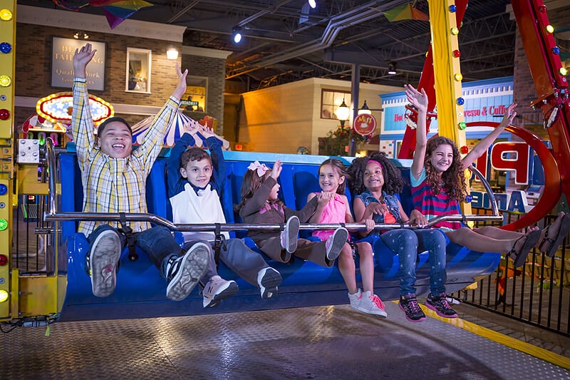 Kids riding the Happy Swing