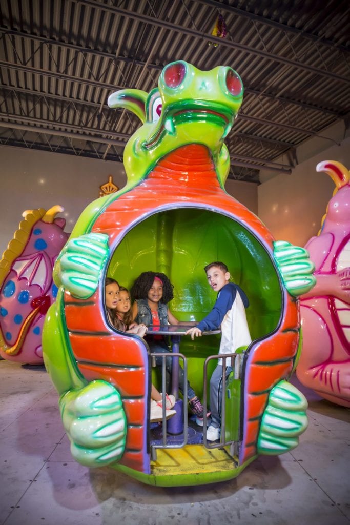 Kids riding the Dizzy Dragons ride